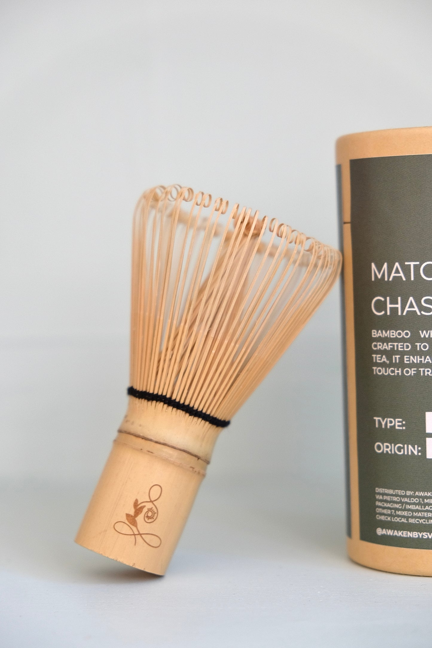 Bamboo whisk and its packaging on a light gray background