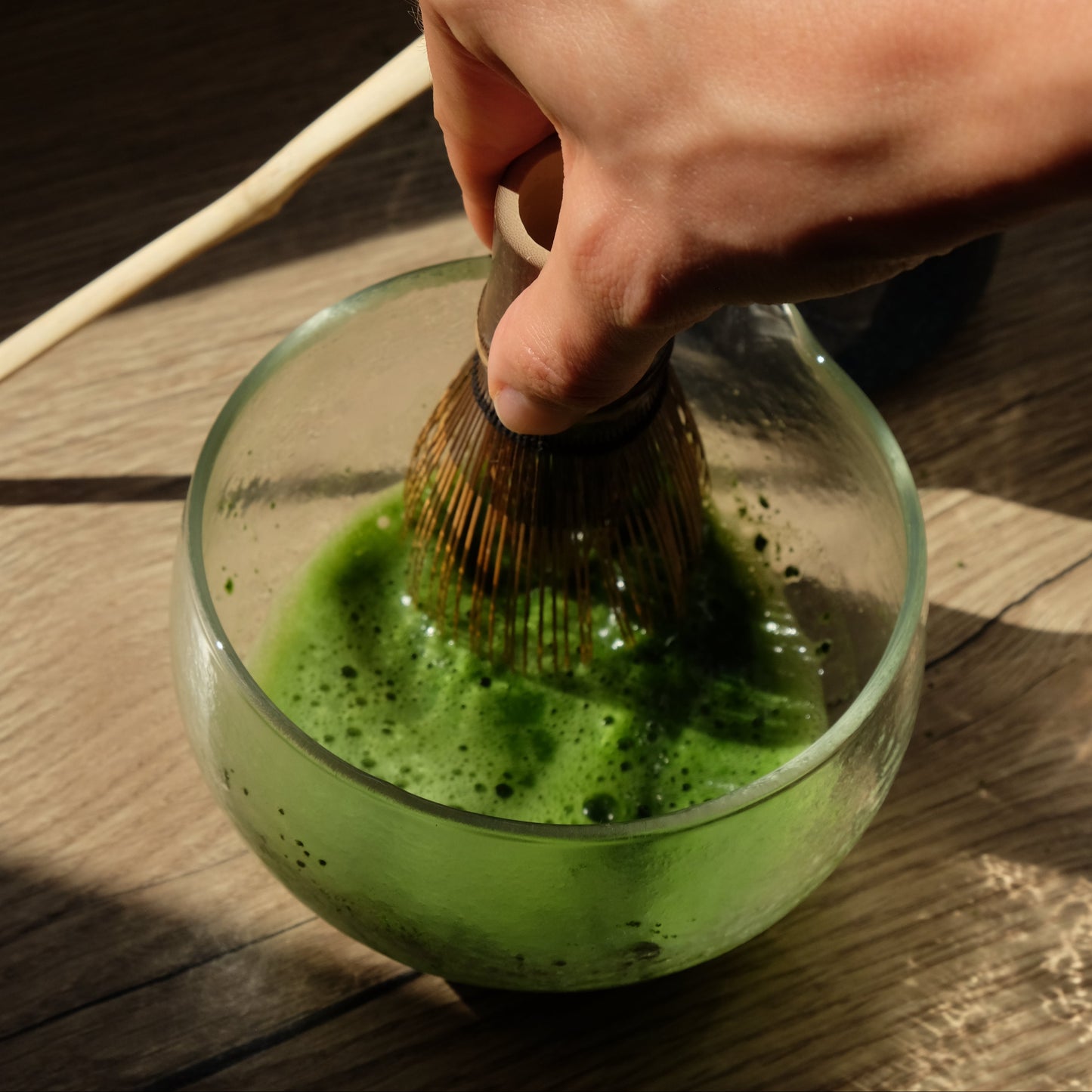 hand whisking first flush matcha, with a chasen