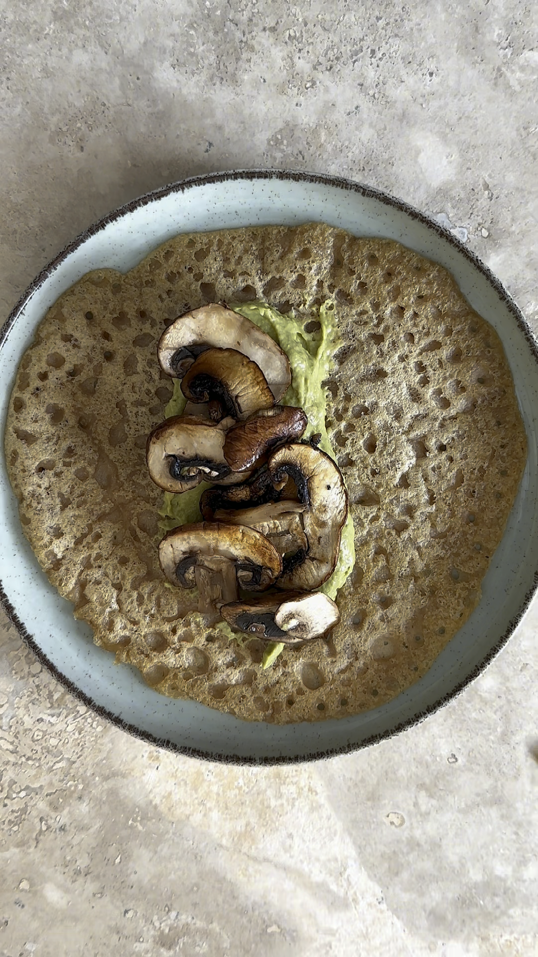 red lentil pancakes with avocado cream and fried mushrooms