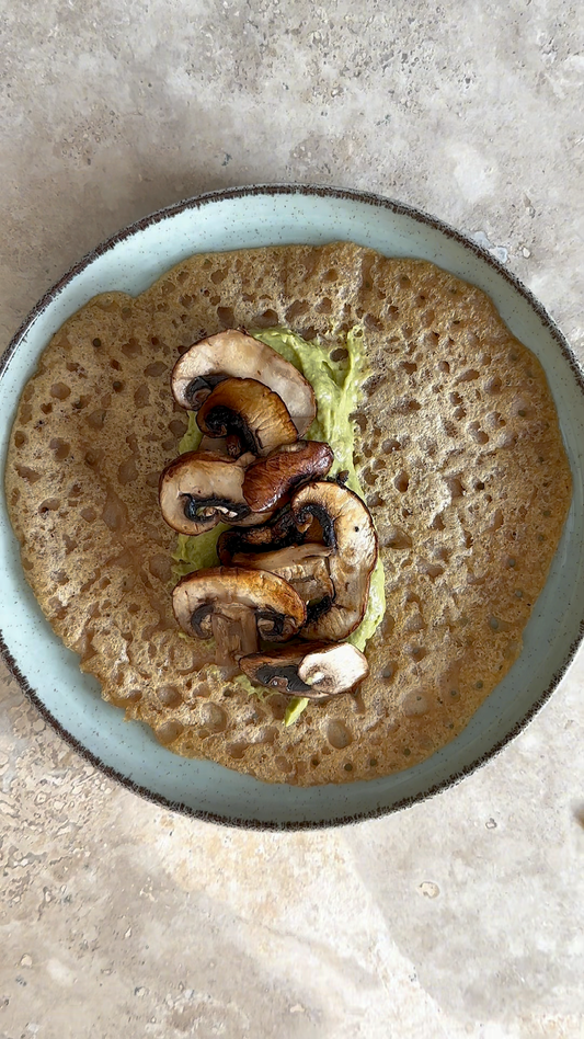 red lentil pancakes with avocado cream and fried mushrooms