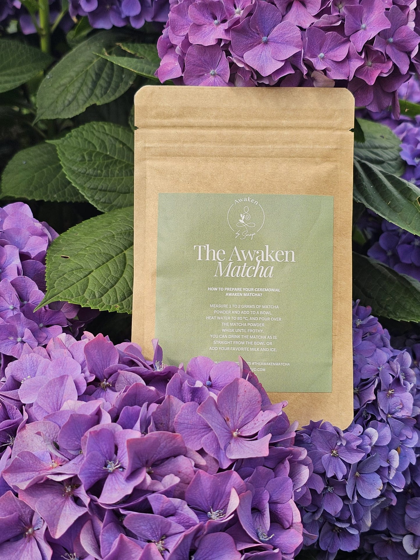 Awaken Matcha kraft paper surrounded by purple flowers