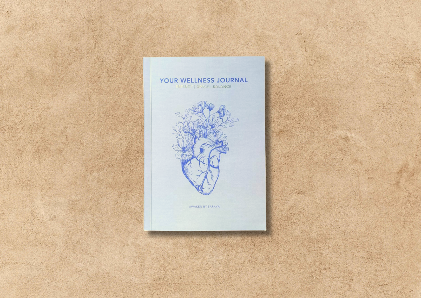 the awaken wellness journal on a neutral background