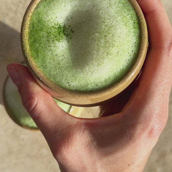 video of Awaken Matcha, a hot matcha latte is being prepared with typical matcha tools