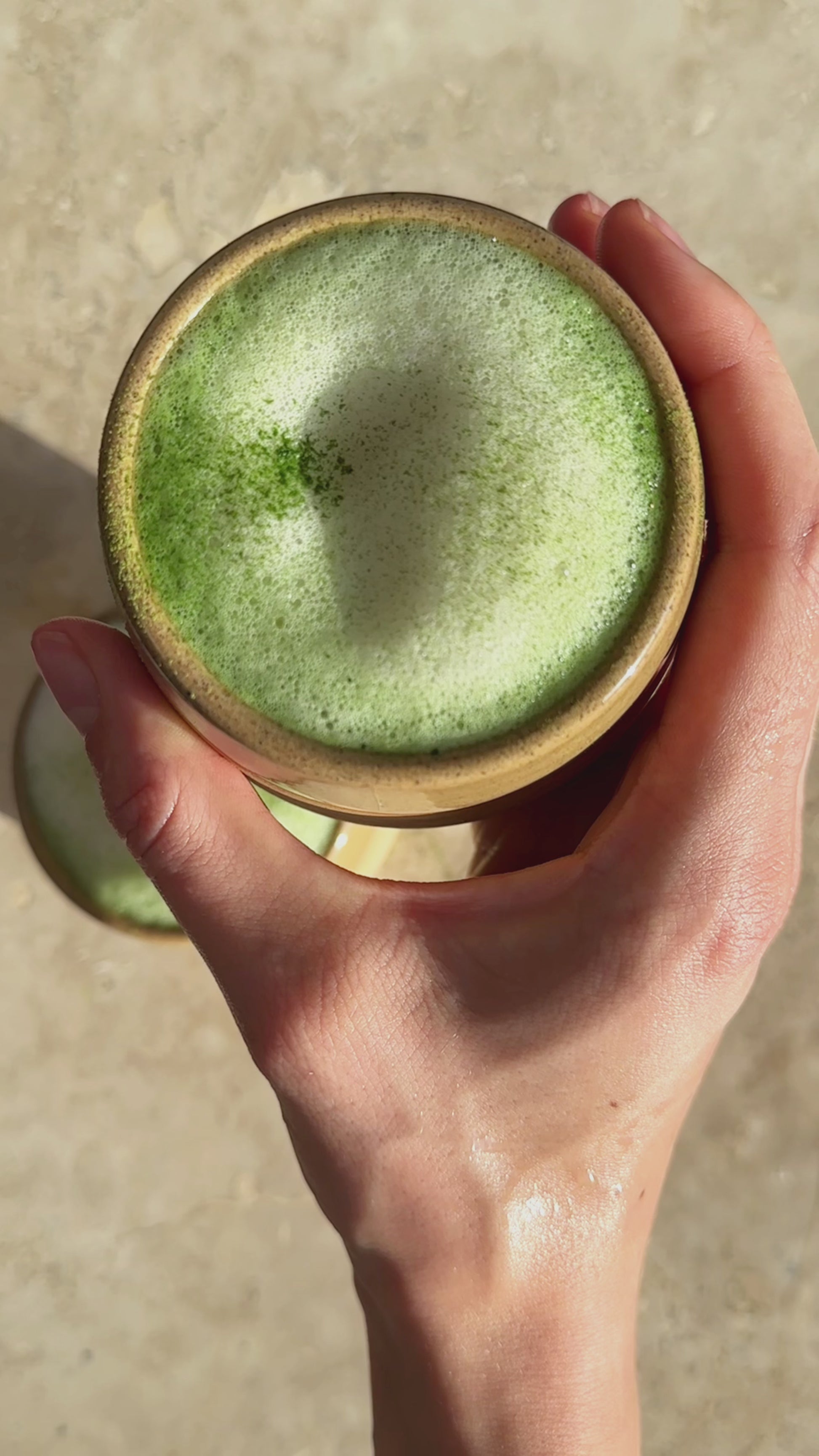 video of Awaken Matcha, a hot matcha latte is being prepared with typical matcha tools